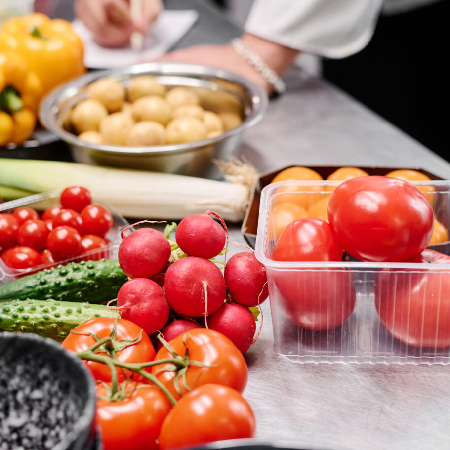 Close-up of fresh ripe vegetables on table for preparing dish in kitchen of restaurant